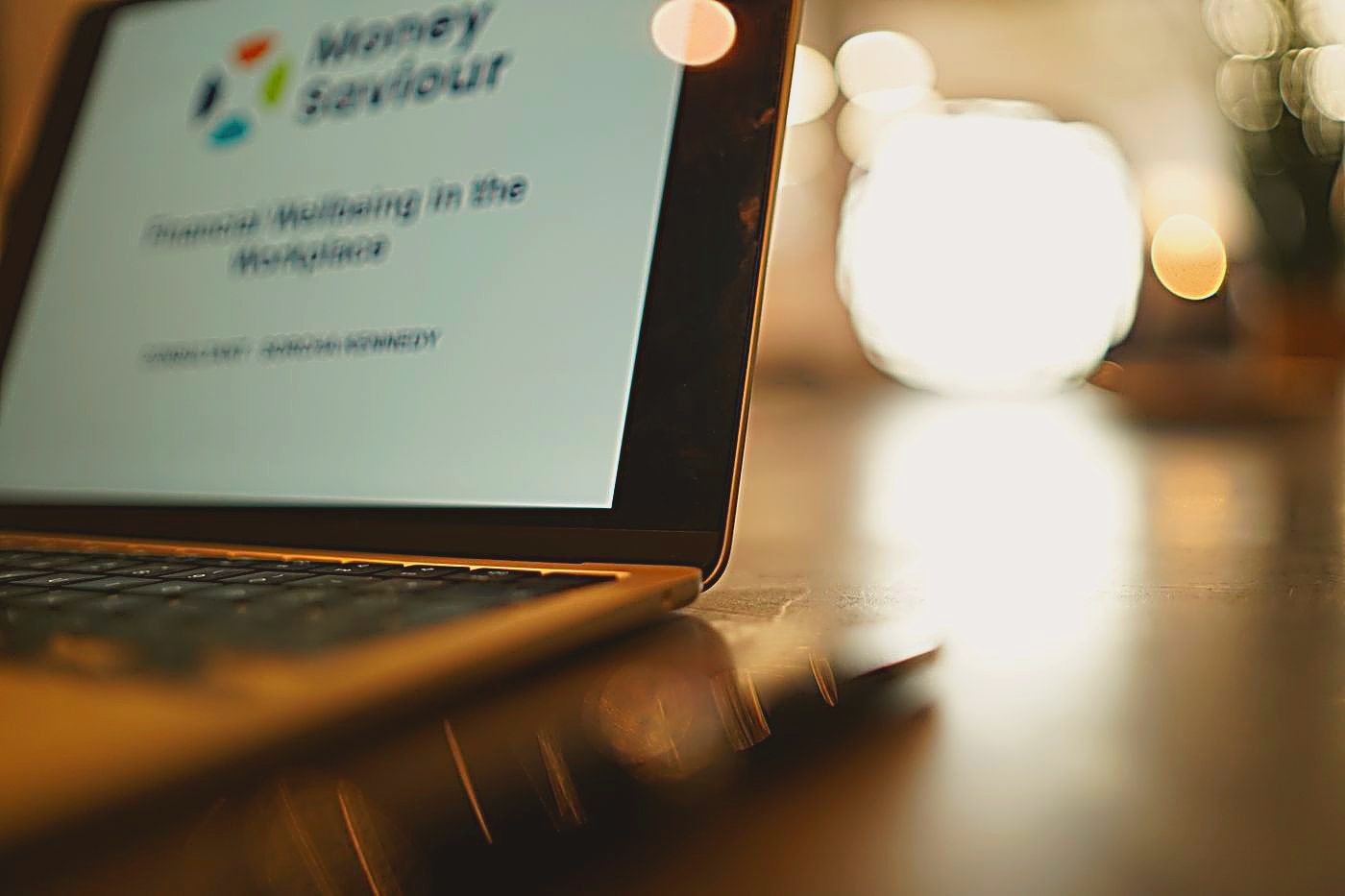 Laptop showing a Money Saviour Financial Wellbeing in the Workplace presentation